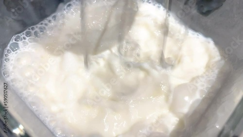 Barista creating foam in the milk, as a delicious and beautiful complement to have a coffee. Close-up, 4k resolution.