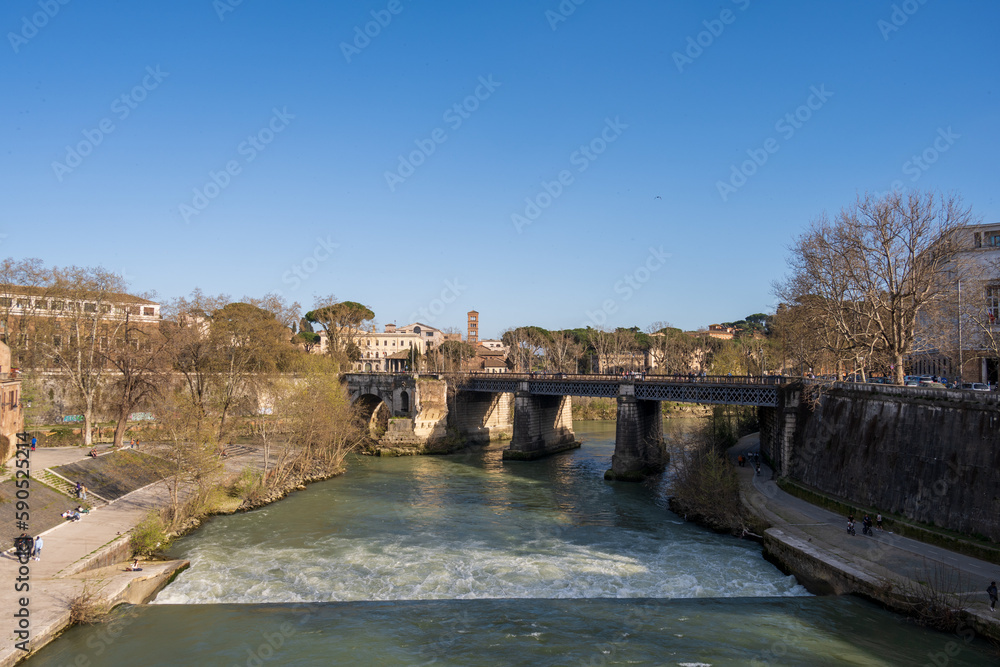 Rom, Italien, Apr. 2023 Der Fluß Tiber bei der Tiberinsel mit der Ponte Rotto und der Ponte Palatino