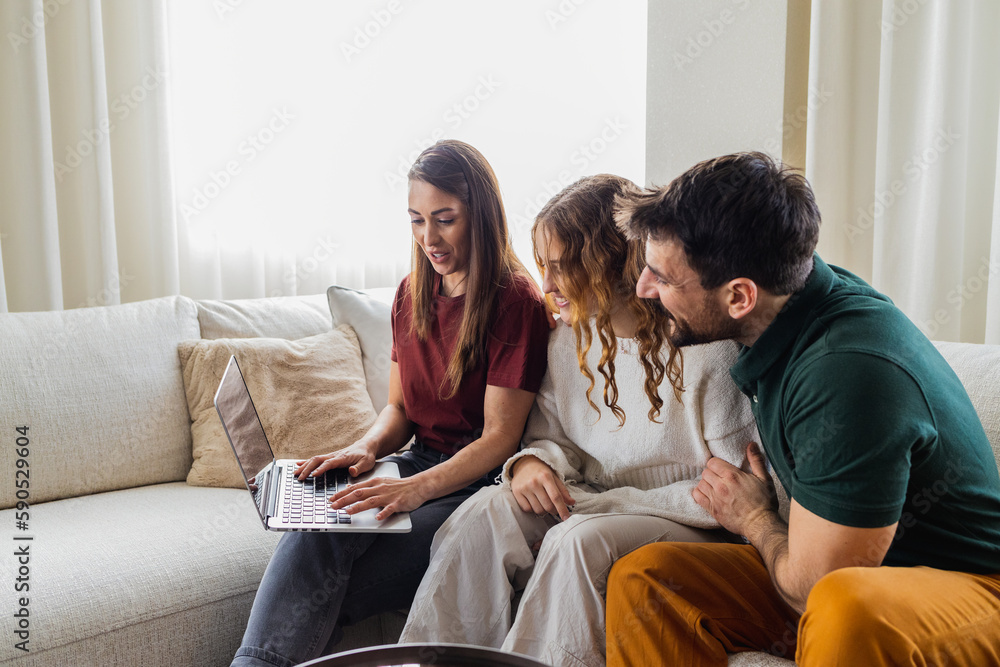 Young mom surfing the internet while the rest of the family watches. Young mom surfing the internet while the rest of the family watches.