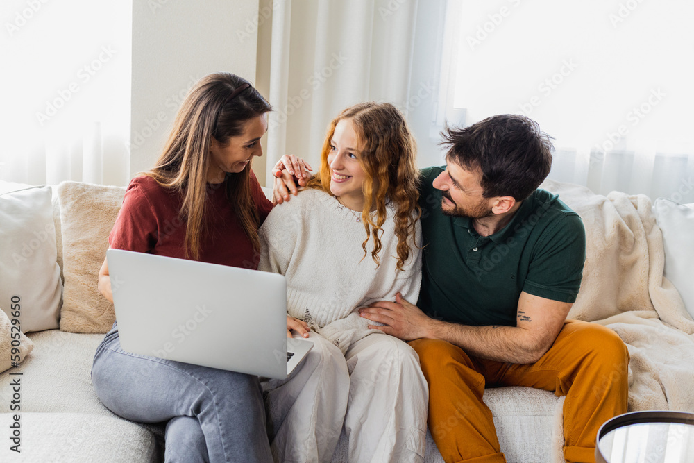 Daughter showing her grades on laptop, parents feeling proud. Daughter showing her grades on laptop, parents feeling proud.