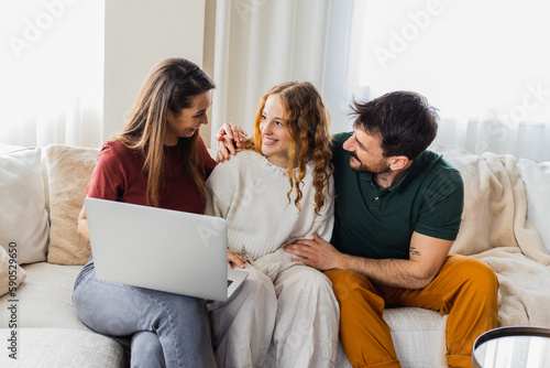 Daughter showing her grades on laptop, parents feeling proud.