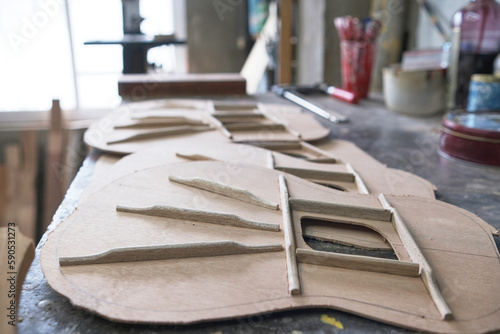 Fotografie several guitar tops on a workbench in the luthier's woodworking shop