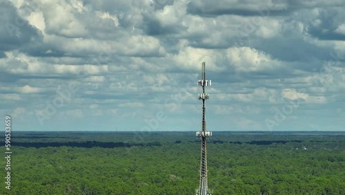 Aerial view of telecommunications cell phone tower with wireless communication 5g antennas for network signal transmission