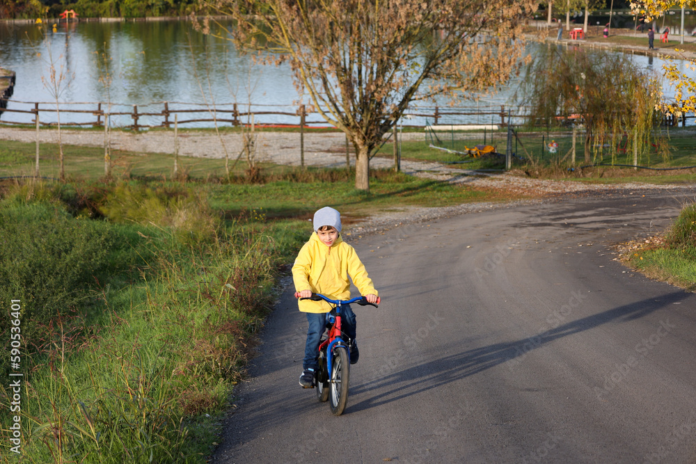 Kid boy of 6 years with bicycle on park road. Healthy lifestyle, environmentally transport concept. Kid boy of 6 years with bicycle on park road. Healthy lifestyle, environmentally transport concept.
