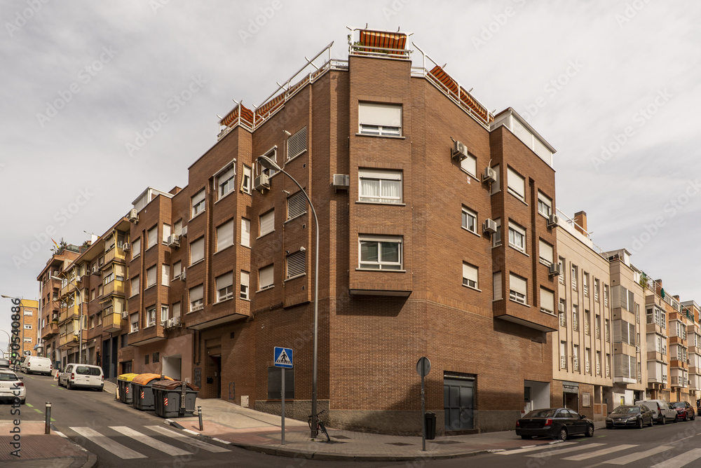 a building with windows of various formats and facades facing two different streets