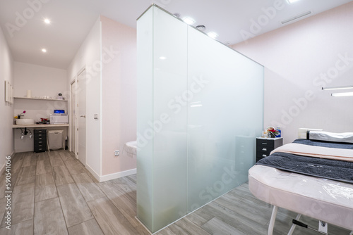 Massage and treatment cabins in a beauty center with tempered glass partitions