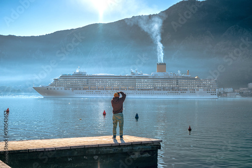 Photographer Takes Photos of a Cruise Ship Near Town Perast, Kotor Bay. Montenegro.