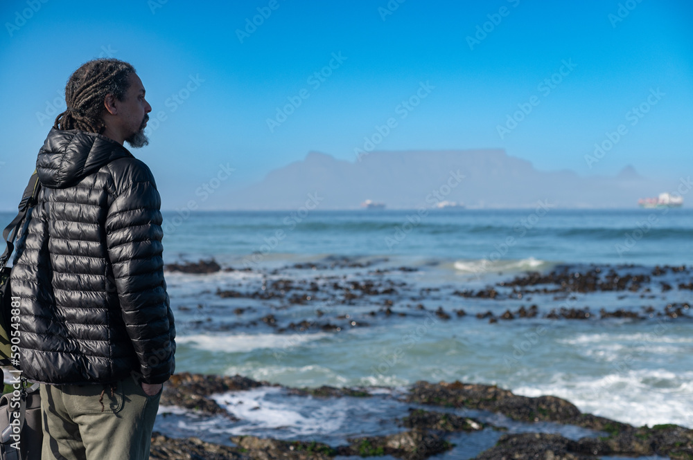 Man standing and looking at ocean