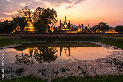 Ancient temples in Sukhothai Historical Park, Thailand, orange sunset