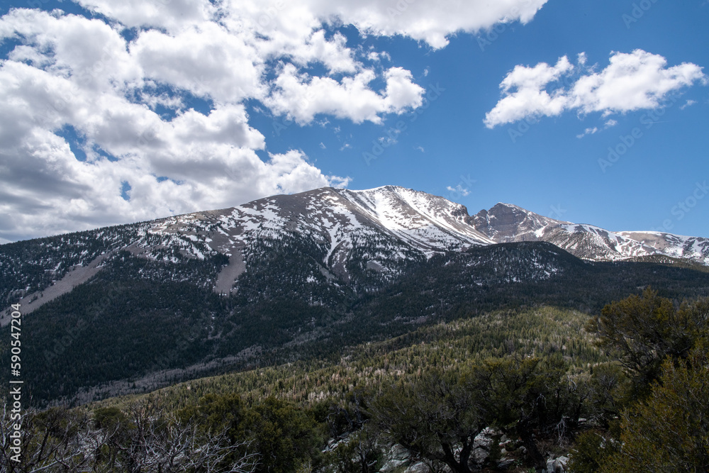 Clouds over mountain with bright blue sky Clouds over mountain with bright blue sky