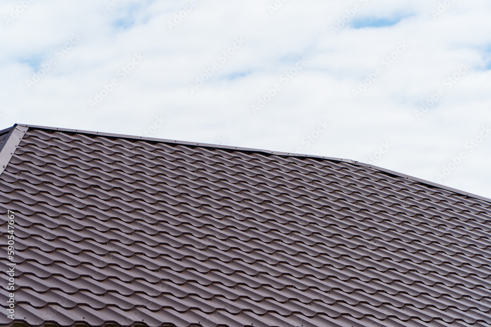 Red metal tile on the roof of the house Red metal tile on the roof of the house