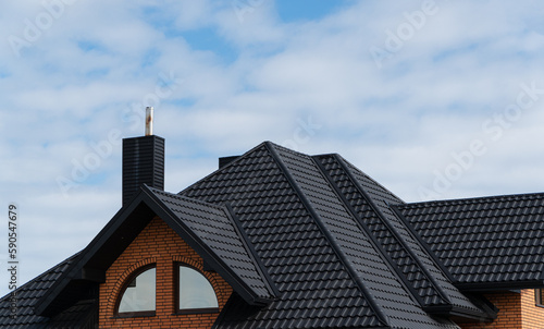 Black metal profile roof installed on a modern house