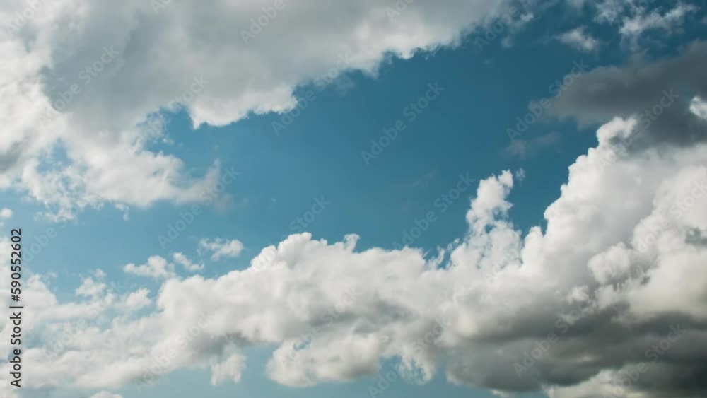 Time-lapse video captures the beauty of white clouds as they drift across a clear blue sky. The changing formations and movements of the clouds create a mesmerizing display of nature's wonders Time-lapse video captures the beauty of white clouds as they drift across a clear blue sky. The changing formations and movements of the clouds create a mesmerizing display of nature's wonders