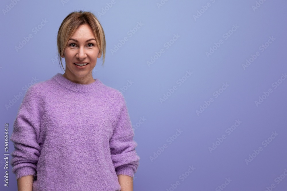 attractive stylish blond young woman in a casual look with a good mood on a bright background with copy space attractive stylish blond young woman in a casual look with a good mood on a bright background with copy space