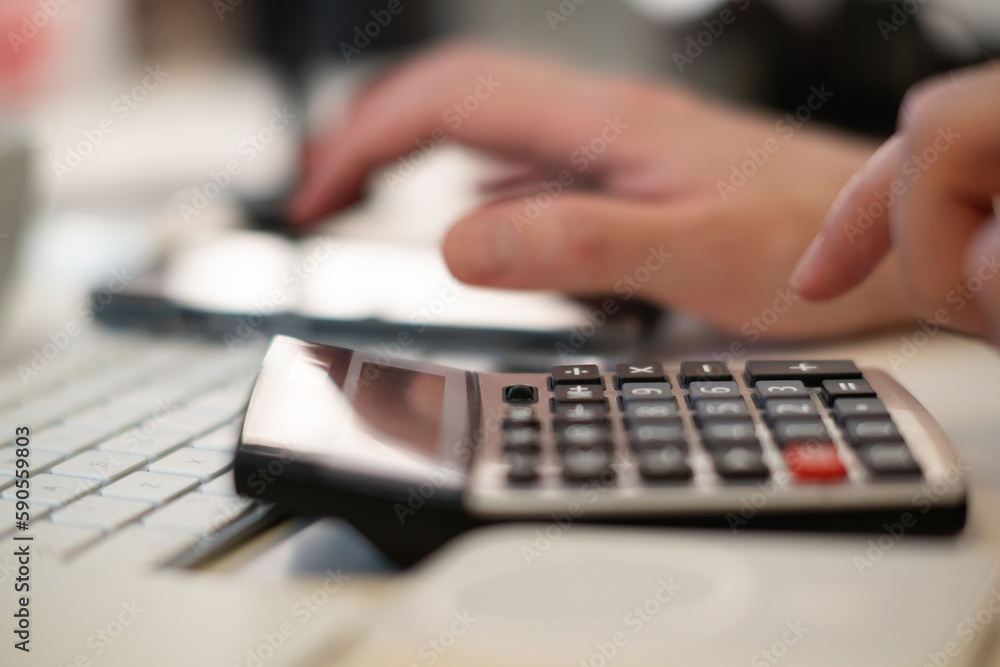 Counting on a calculator. Counting bills, home accounting office Counting on a calculator. Counting bills, home accounting office