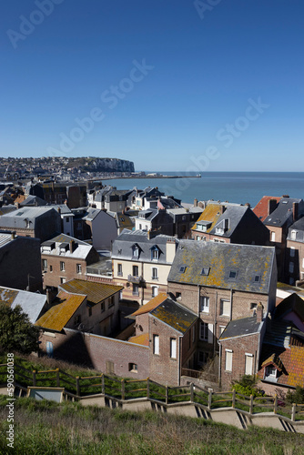 Aerial view across the rooftops looking towards LeTreport from Mers-le-Bains in the Somme department of Hauts-de-France. Beautiful spring day with clear blue sky, sea view and cliffs. Copy space above photo