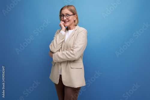 a strict serious adult woman with a bob haircut stands thoughtfully on a bright background with copy space