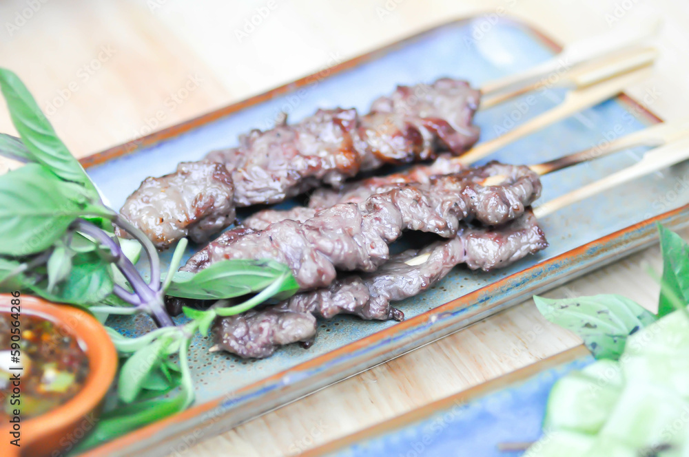 barbecued beef or grilled beef , beef satay with sauce