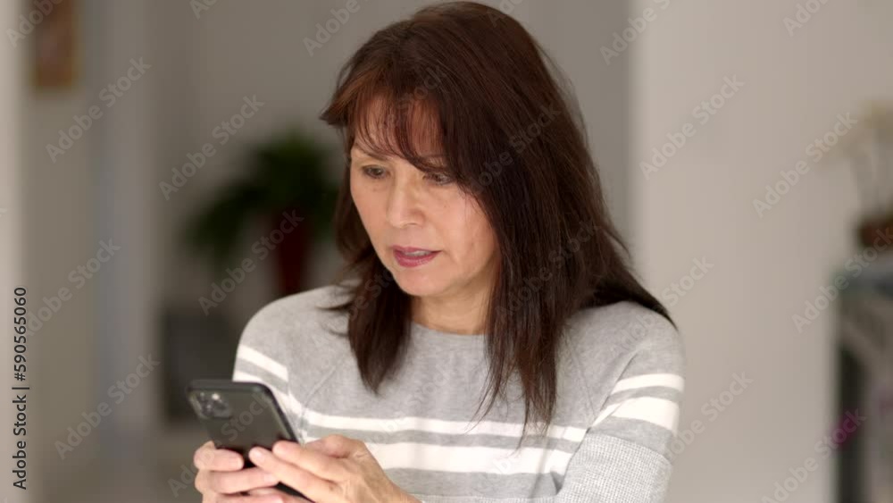 Stylish woman enjoying reading, texting email messages on mobile cell phone sitting at home Stylish woman enjoying reading, texting email messages on mobile cell phone sitting at home