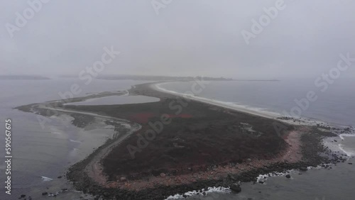 Winter Atlantic coast, sand spit in the ocean in winter aerial footage
