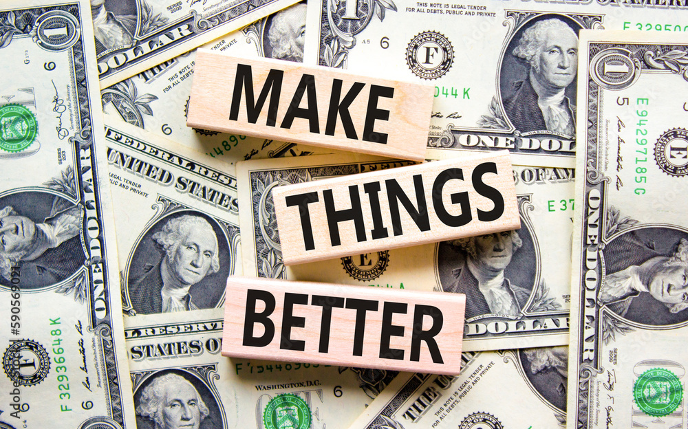 Make things better symbol. Concept words Make things better on wooden block on a beautiful background from dollar bills. Dollar bills. Business and make things better concept. Copy space.