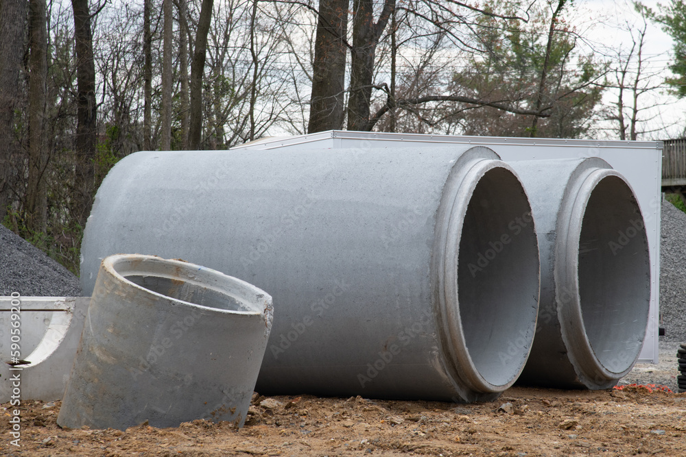 stacked cement pipes at concrete factory, outdoors warehouse stacked cement pipes at concrete factory, outdoors warehouse