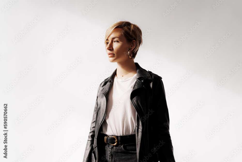 Portrait of smiling young female with blond hair looking at camera while standing alone on white background Portrait of smiling young female with blond hair looking at camera while standing alone on white background