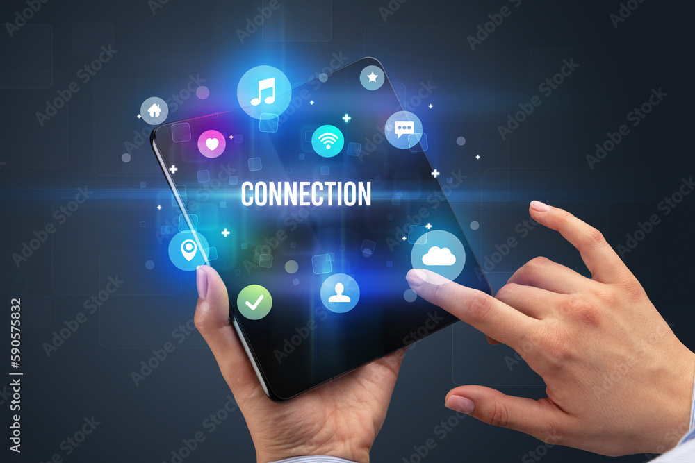 Businessman holding a foldable smartphone Businessman holding a foldable smartphone