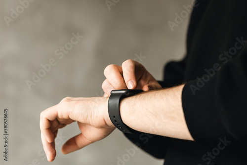 Close up shot of a businessman's hand that uses a smart watch, business and technology concept, copy space.