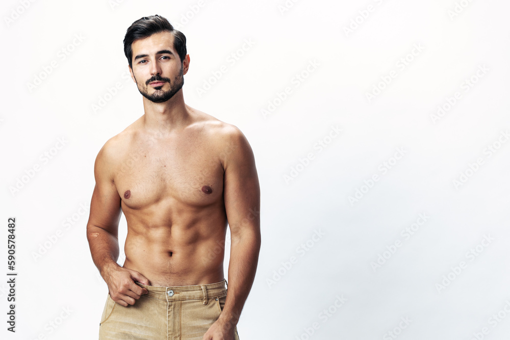 Man athlete model with a naked torso and six pack abs sporty inflated figure and tan on a white isolated background, fashionable clothing style, copy space, space for text