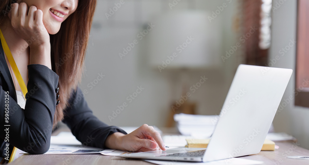 Asian Business person makes analysis and research financial report at office, analyzes profits. Accountant checks status of financial Asian Business person makes analysis and research financial report at office, analyzes profits. Accountant checks status of financial