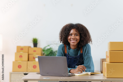 American African entrepreneur smile and checking online order. Successful SME entrepreneur concept © itchaznong