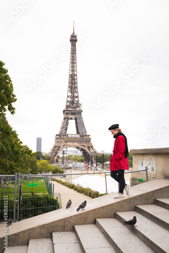 Woman walking in Paris (in front of Eiffel Tower) © Giancarlo