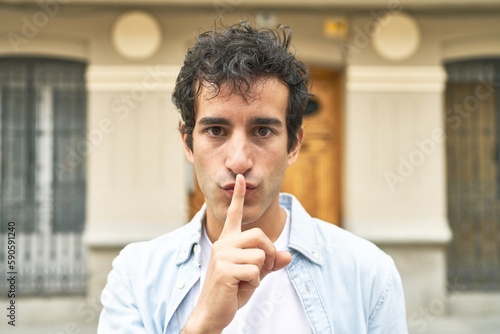 Photography Young handsome caucasian man at outdoor keeping a secret or asking for silence
