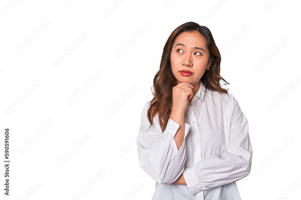 A young chinese woman looking sideways with doubtful and skeptical expression. A young chinese woman looking sideways with doubtful and skeptical expression.