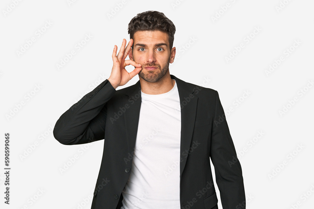 Young business man with fingers on lips keeping a secret. Young business man with fingers on lips keeping a secret.