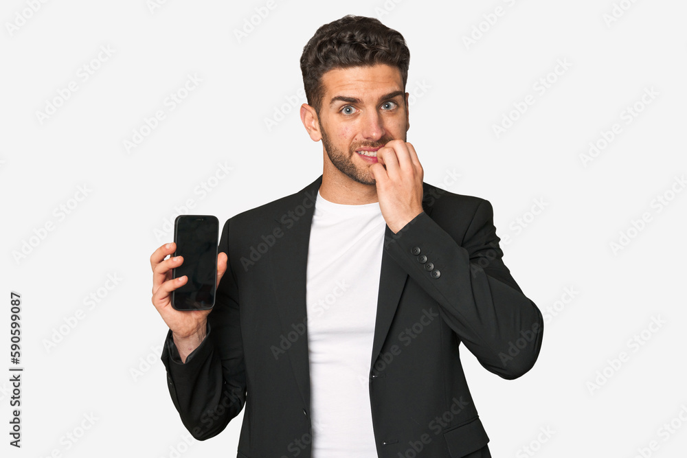 Young business caucasian man biting fingernails, nervous and very anxious.