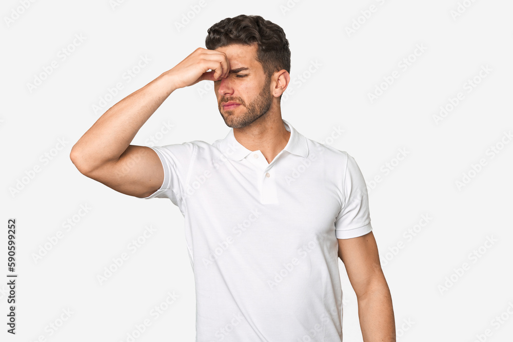 Young handsome man isolated having a head ache, touching front of the face. Young handsome man isolated having a head ache, touching front of the face.