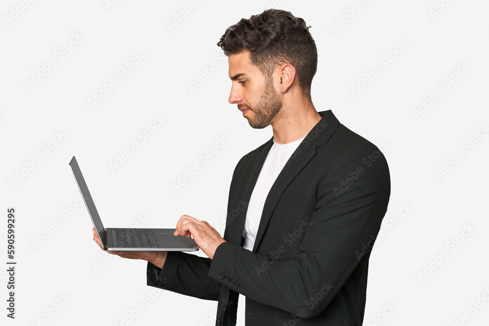 Young businessman focused on his laptop, utilizing technology for enhanced productivity and success in his professional career. Young businessman focused on his laptop, utilizing technology for enhanced productivity and success in his professional career.