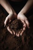 hands collect soil and fertilizer