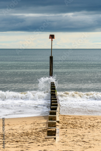 A wave hitting one of the groynes on Bournemouth Beach, UK