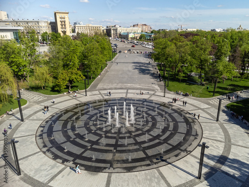 Spring city aerial greenery on Freedom Svobody Square with a circle fountain. Kharkiv, Ukraine