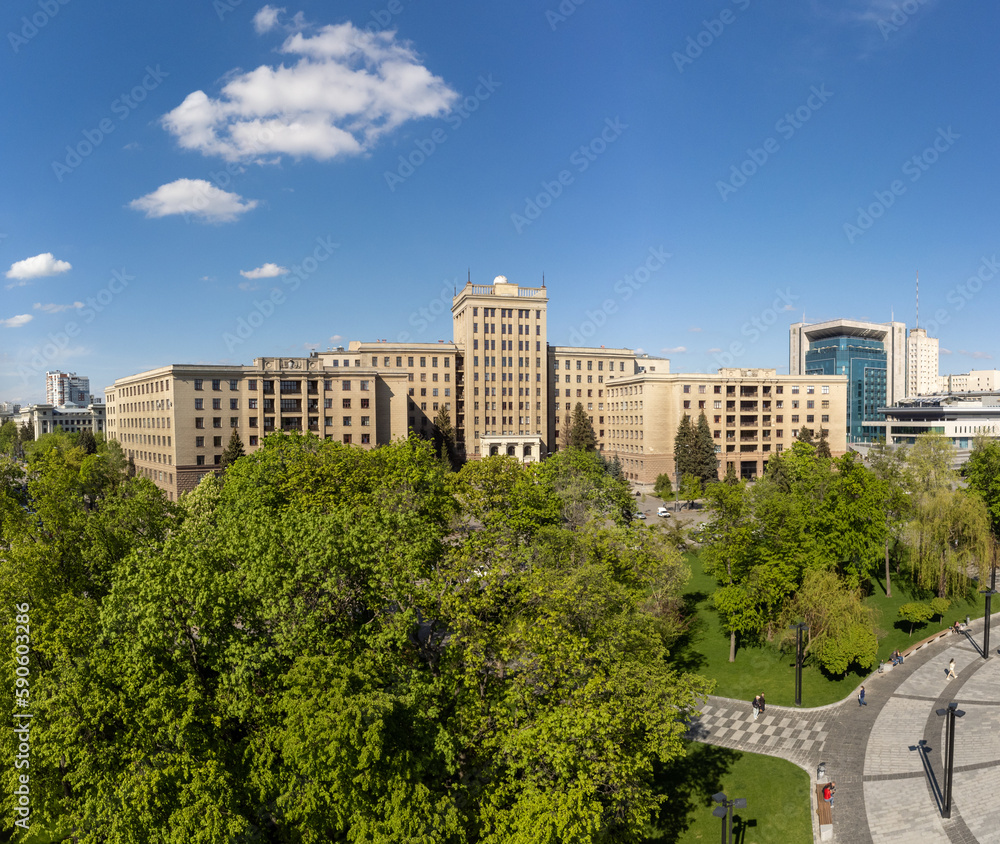 Aerial city view on Karazin National University northern building on Freedom square, green park and blue sky in spring Kharkiv, Ukraine