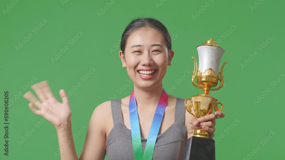 Close Up Of Asian Woman With A Gold Medal And Trophy Waving Her Hand ...