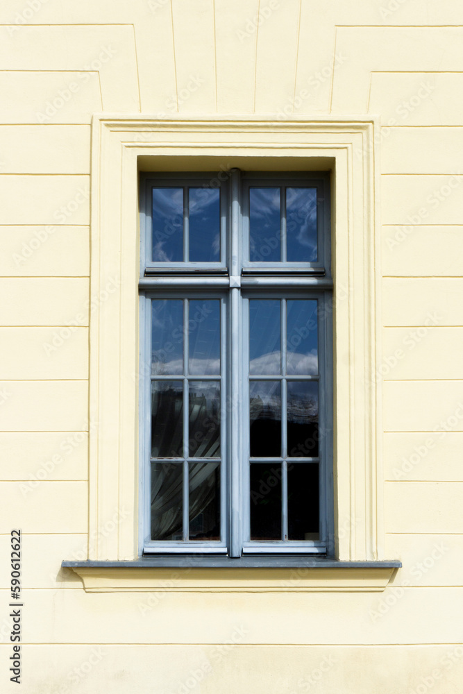 Simple window background. Urban architecture. Yellow paint facade.