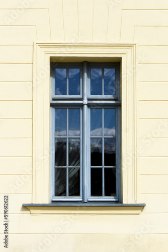 Simple window background. Urban architecture. Yellow paint facade.