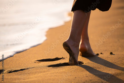 Sandy Steps: A Girl Walking on the Beach
