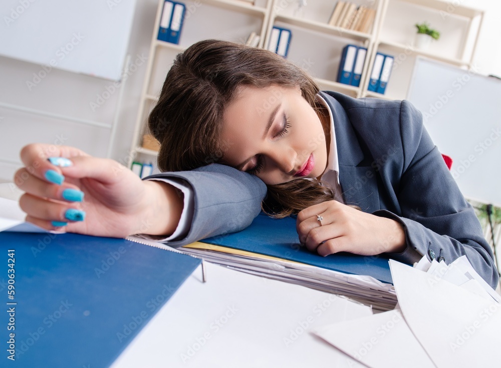 Naklejka premium Beautiful female employee unhappy with excessive work