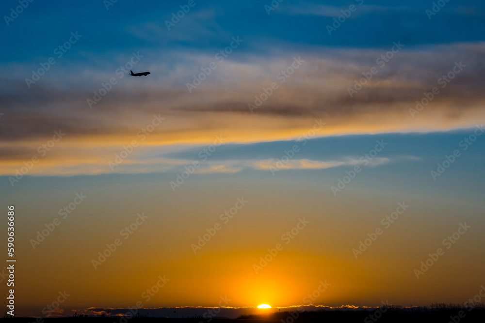Airplane on the sunset sky in Budapest