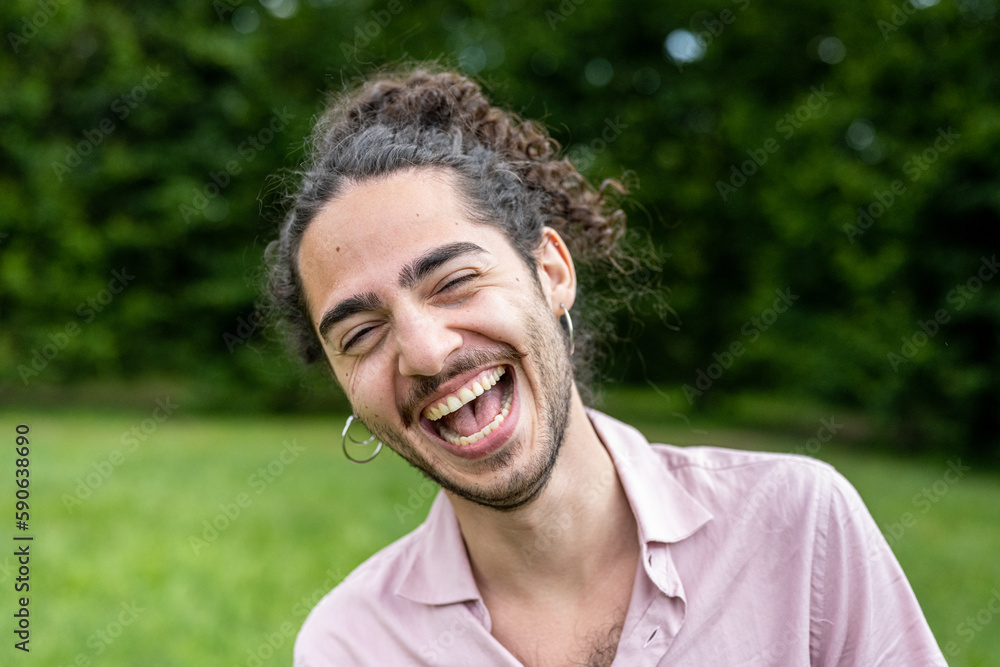 Portrait of a young man with long hair and beard, man of Latin and Caucasian origins Portrait of a young man with long hair and beard, man of Latin and Caucasian origins